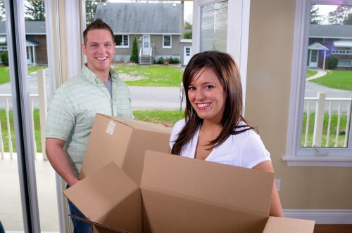 Moving van supporting small removals in Isle of Dogs near modern riverside apartments